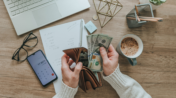 Photo of a hand taking money out of a wallet