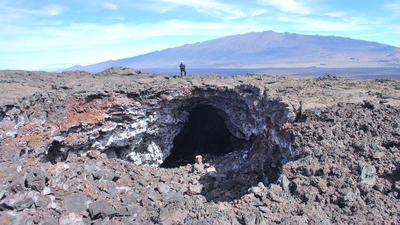 Mission commander Musilova stands atop a "skylight" &mdash; a lava tube with a collapsed roof &mdash; at Mauna Loa in Hawaii.