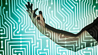 Hand in the middle of microchip light projection.