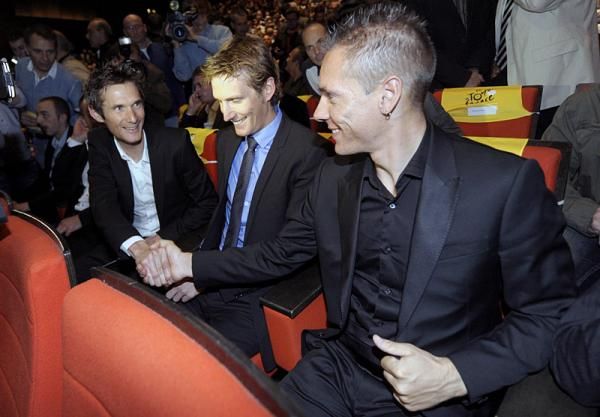 Frank and Andy Schleck take their seats next to Philippe Gilbert.