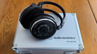 Photos of the Audio-Technica ATH-ADX7000 headphones on a wooden table
