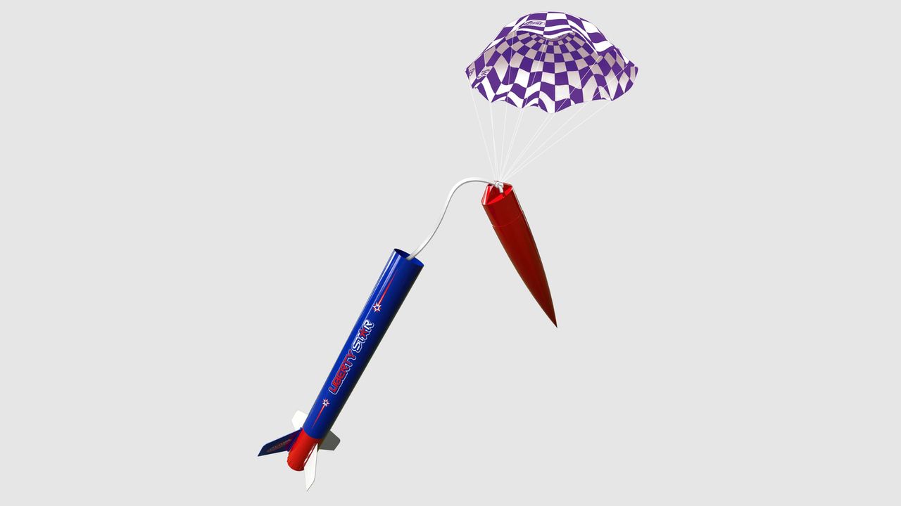 The Estes Liberty Star with nose cone detached and parachute deployed on a grey background.