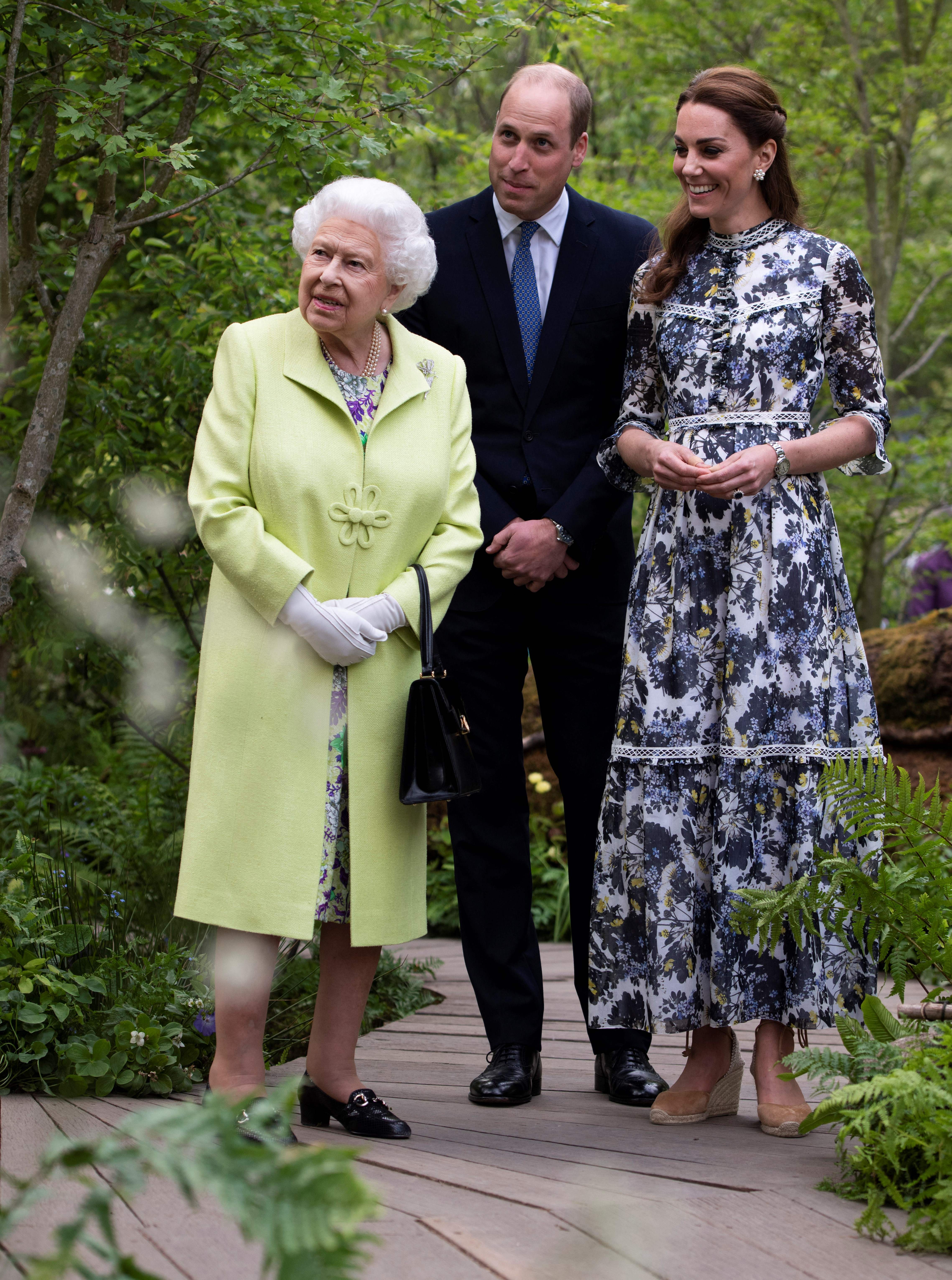 Queen Elizabeth, Princess Kate and Prince William looking at the Back to Nature Garden at the 2019 Chelsea Flower Show
