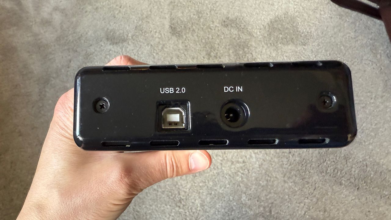 An old external hard drive in hand.