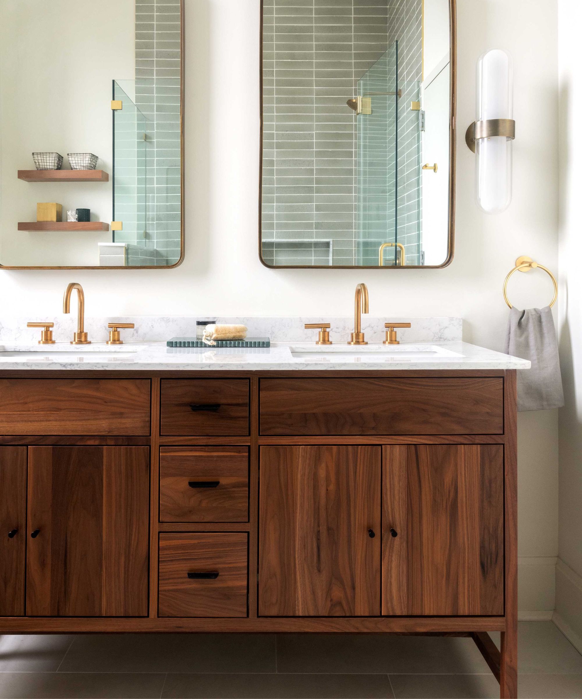 Bathroom with dark wooden vanity and two mirrors above two sinks