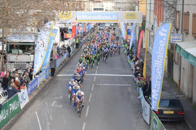 Topsport Vlaanderen-Baloise leads the peloton across the finish line in Saint-Ambroix as the riders face five laps of a finishing circuit