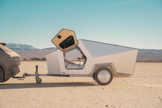 Polydrops P17A1 All Electric caravan with doors opened upwards, in desert landscape
