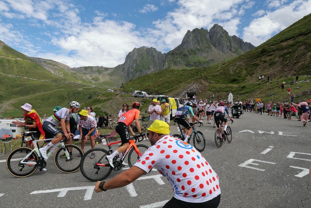 Alpecin-Deceuninck team's Belgian rider Mathieu Van Der Poel (L) cycles in a breakaway in the ascent of Col du Tourmalet during the 14th stage of the 111th edition of the Tour de France cycling race, 151,9 km between Pau and Saint-Lary-Soulan Pla d'Adet, in the Pyrenees mountains in southwestern France, on July 13, 2024. (Photo by Thomas SAMSON / AFP)