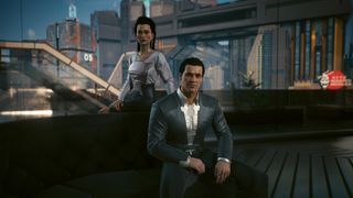 Cyberpunk 2077: Jefferson Peralez sits on a couch while his wife Elizabeth Peralez stands behind him to his left