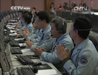 China's Chang'e 3 mission control team applauds after the successful landing of the Chang'e 3 lander carrying the Yutu rover on Dec. 14, 2013. This view is a still from a broadcast by the state-run CNTV.