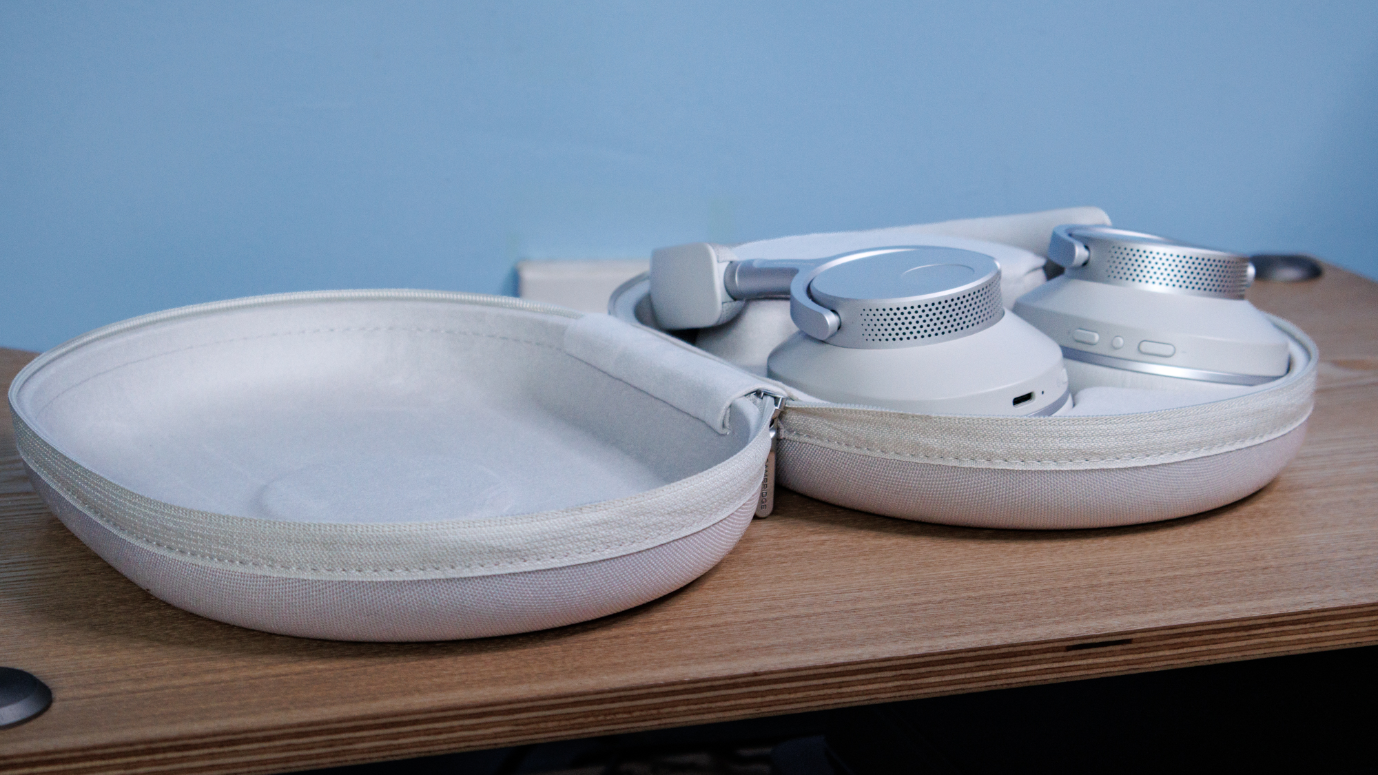 Cambridge Audio Melomania P100 SE headphones in their case on a table.