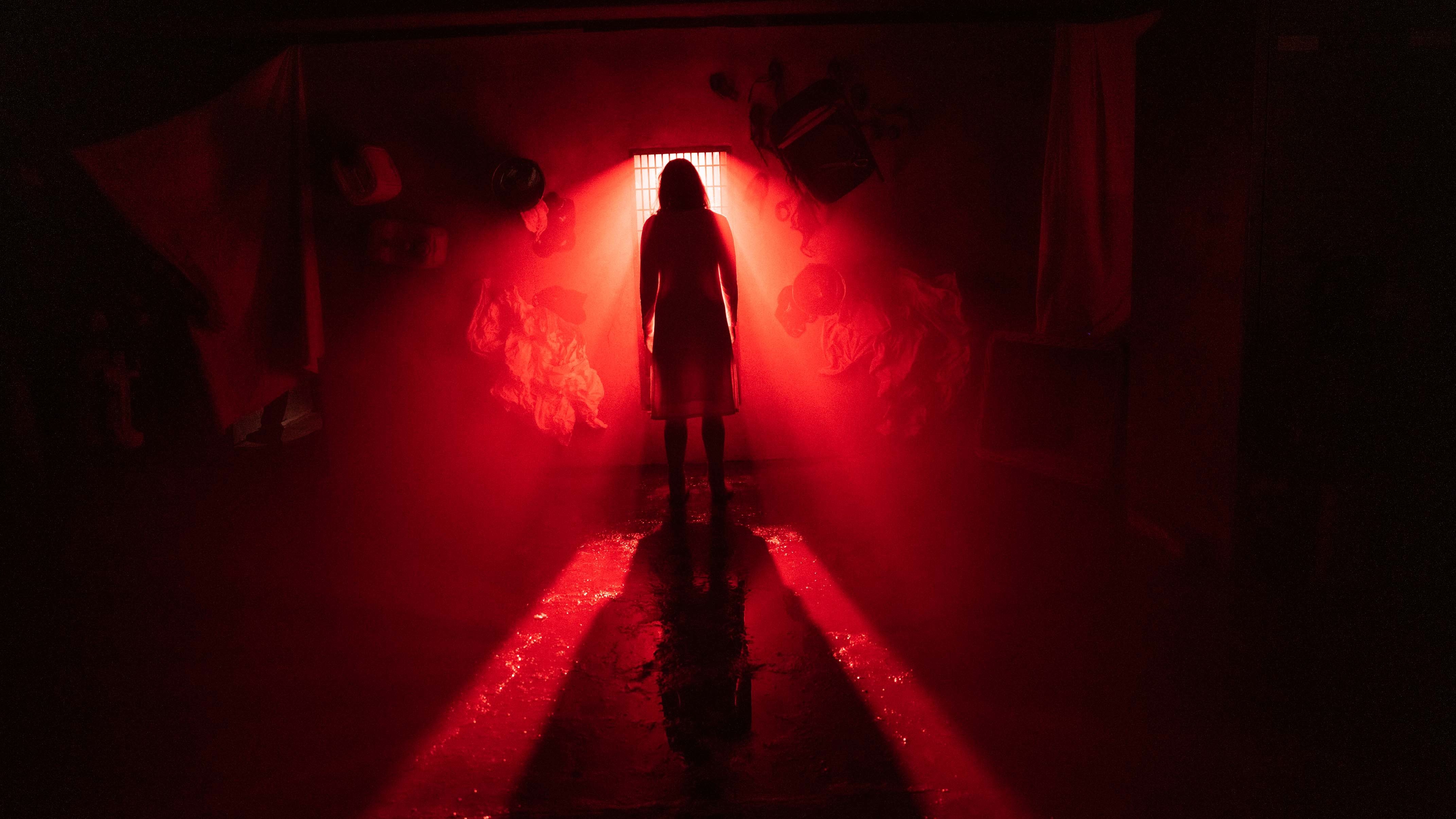 Lorna Brady in a red-tinted room in The Woman in the Wall episode 6