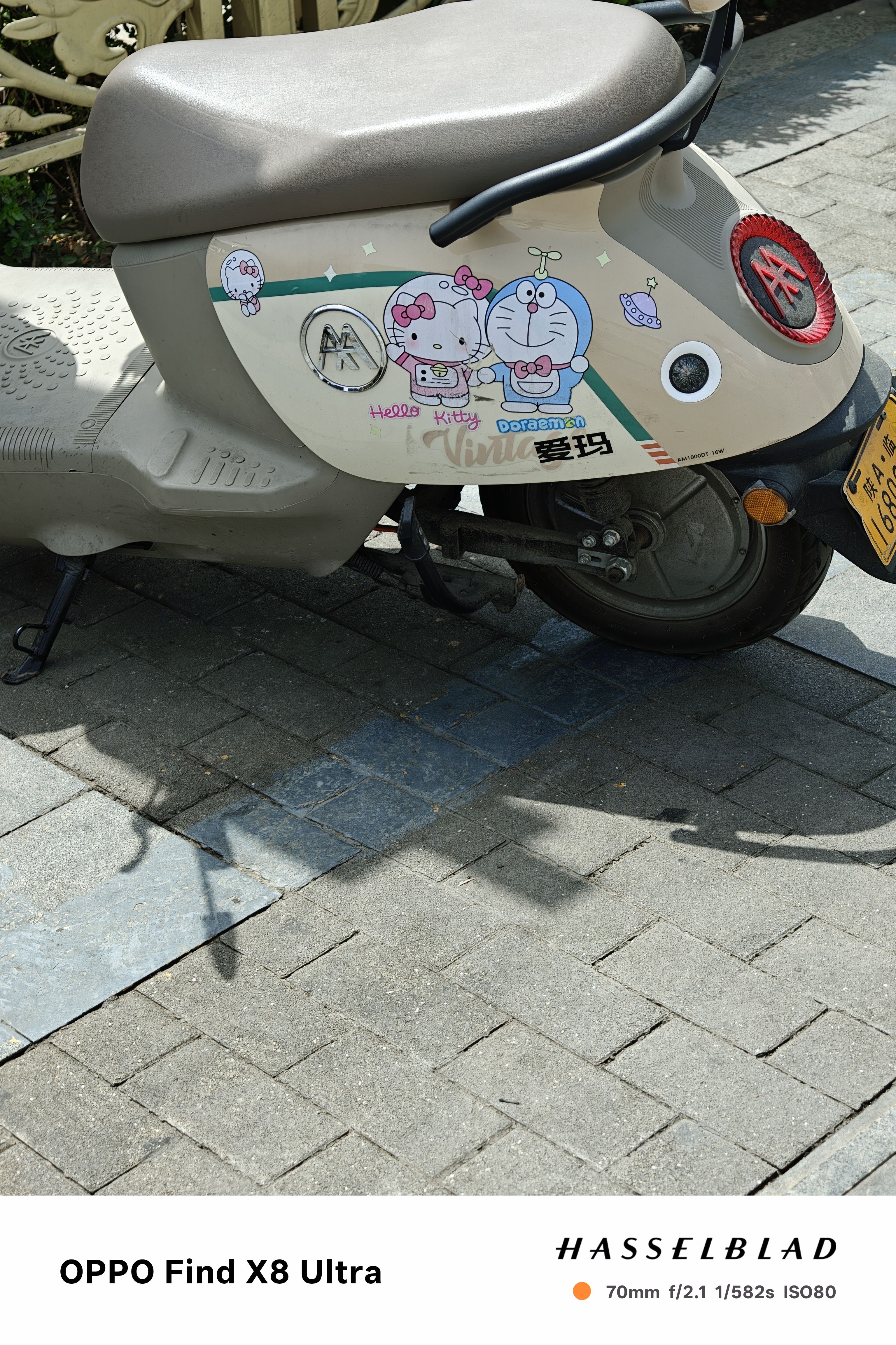 A moped decorated with stickers of cartoon characters