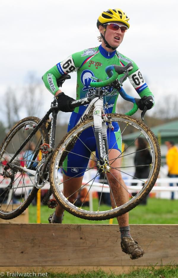 Rebeccca Wellons (Quad Cycles) lifting her bike over the barriers