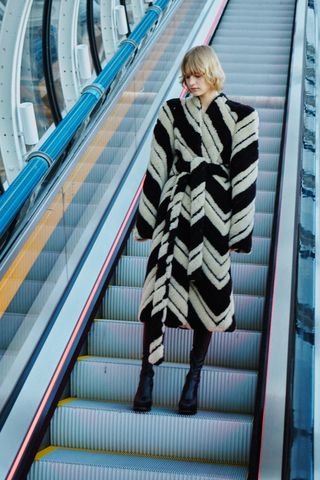 Model on escalator at Centre Pompidou wears Stella McCartney