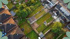aerial view of british suburban housing with back gardens