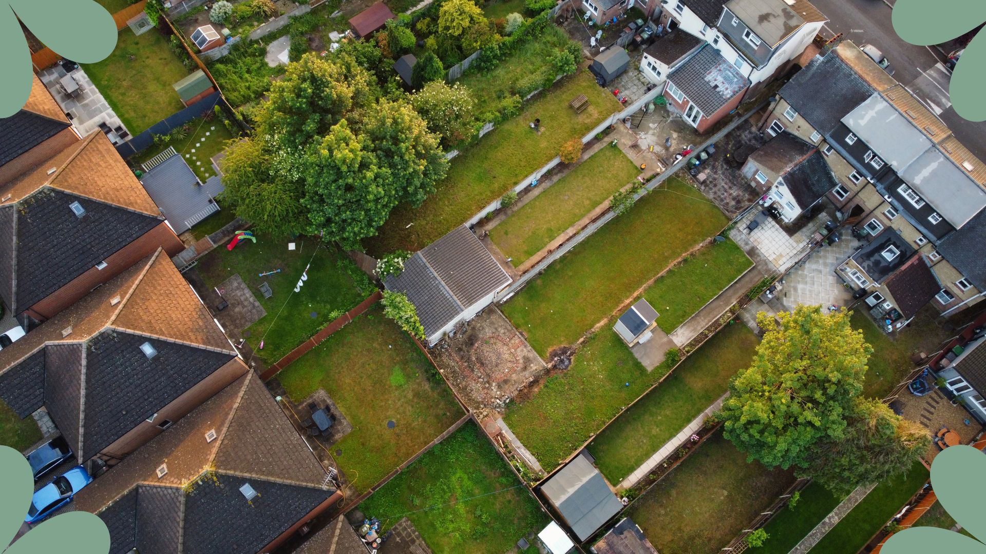  aerial view of british suburban housing with back gardens 