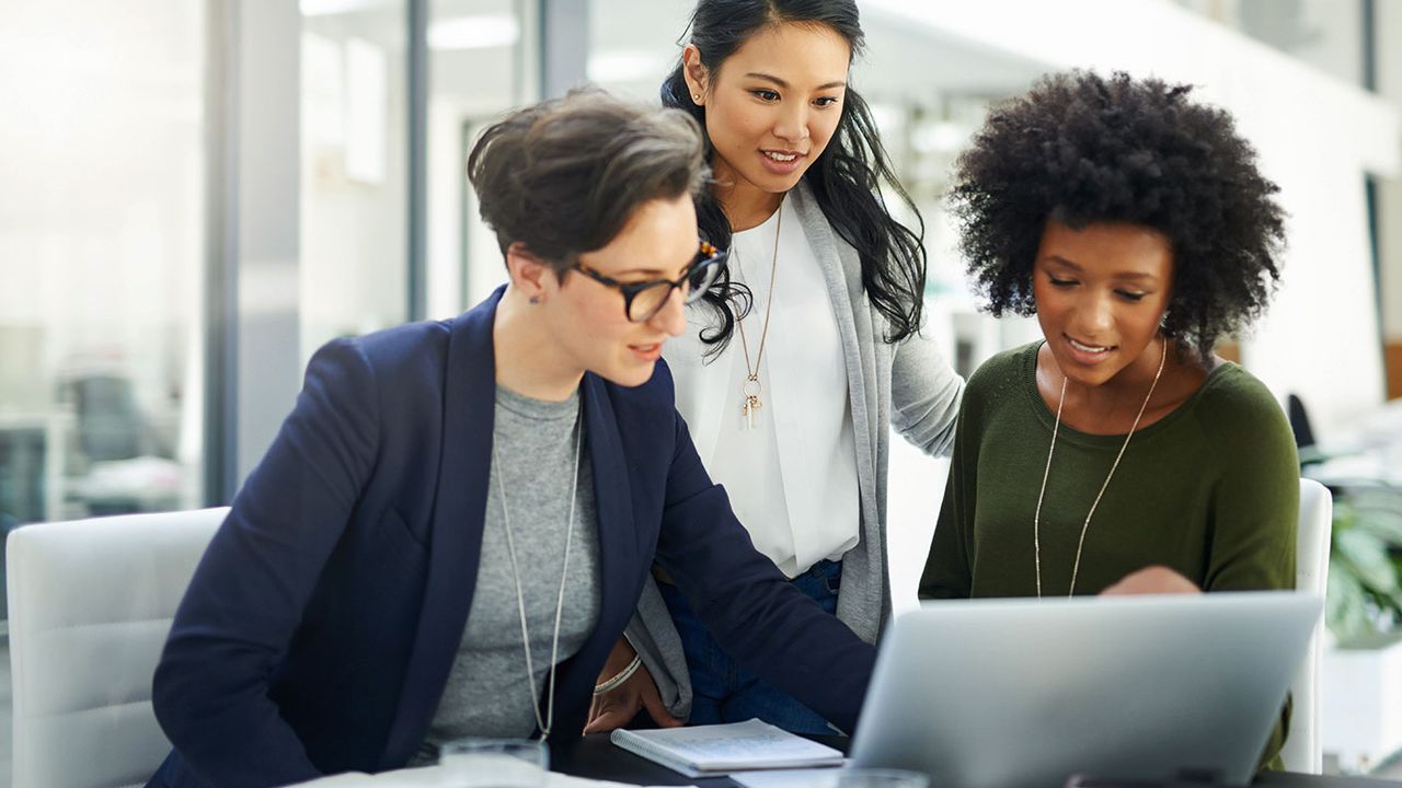 Three women looking at a laptop 