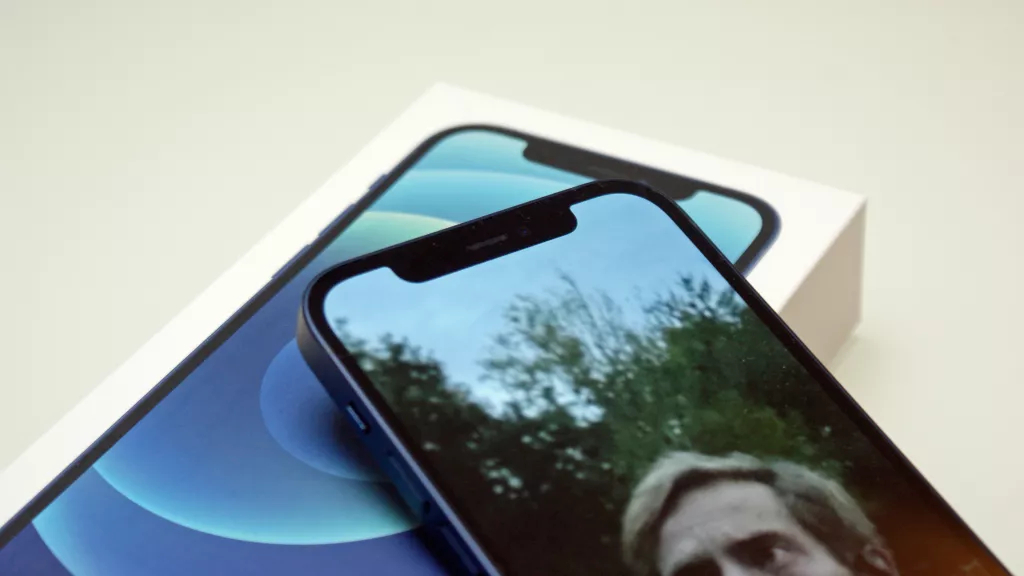 An iPhone 12 with the notch in focus