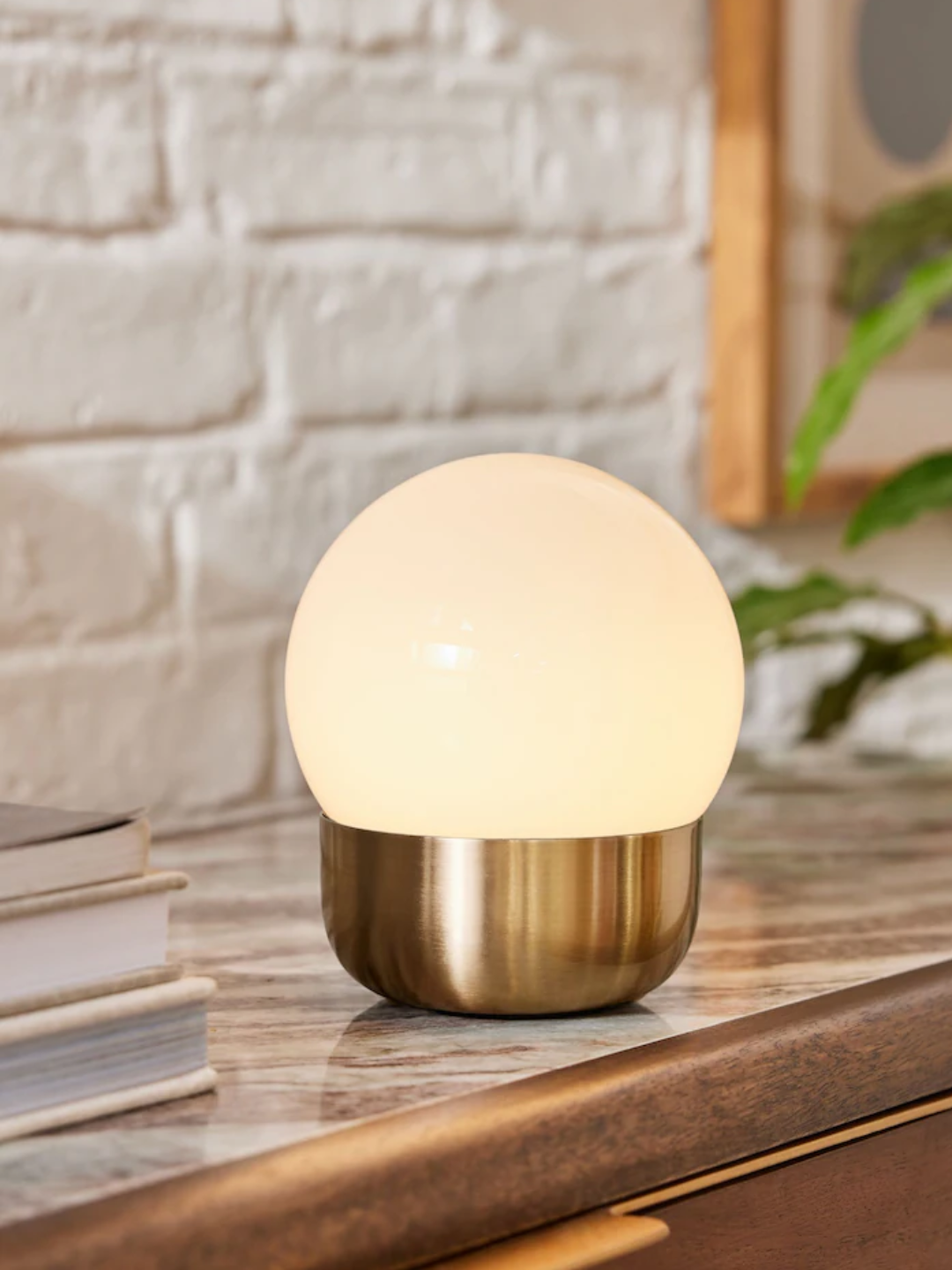 A brass pod rechargeable wireless touch lamp from Next