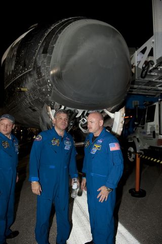 STS-134 Mission Specialist Mike Fincke, left, Pilot Greg H. Johnson and Commander Mark Kelly talk with employees following the successful return of space shuttle Endeavour to NASA's Kennedy Space Center in Florida, on June 1, 2011.
