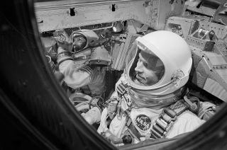 Astronauts Gordon Cooper (foreground) and Charles Conrad are pictured in the Gemini 5 spacecraft moments before the hatches were closed for launch on Aug. 21, 1965.