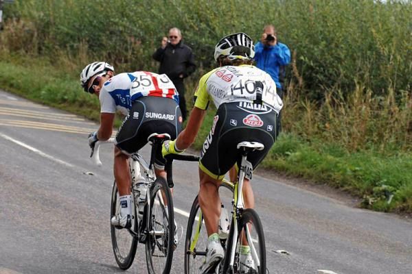 Richie Porte (Saxo Bank) checks behind to the peloton with Patrik Sinkewitz (ISD - Neri) on his wheel.