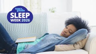 The image shows a woman with dark curly hair sleeping on her back on a sofa, with her arms tucked behind her head. A book lies open on her stomach. A blue Tom's Guide Sleep Awareness Week 2026 logo sits in the top left hand corner.