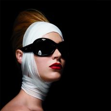 woman with sunglasses and ace bandages wrapped around her face and neck