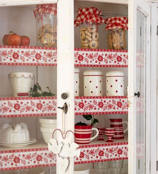 kitchen dresser with Christmas crockery and red and white braid
