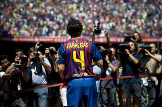 Cesc Fabregas is welcomed by Barcelona fans at his official presentation at Camp Nou after signing from Arsenal in 2011.