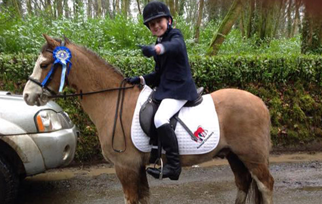 my 9 y_o little girl proudly displaying her 2nd prize rosette for Dressage (competing against adults!) she also came 5th in her next class