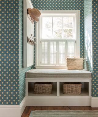 mudroom with built in storage with wall hooks, baskets and cushioned seat - Liliane Hart