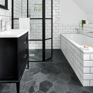 bathroom with white metro tiles and geometric floor tiles
