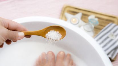 Person using bath salts for running recovery
