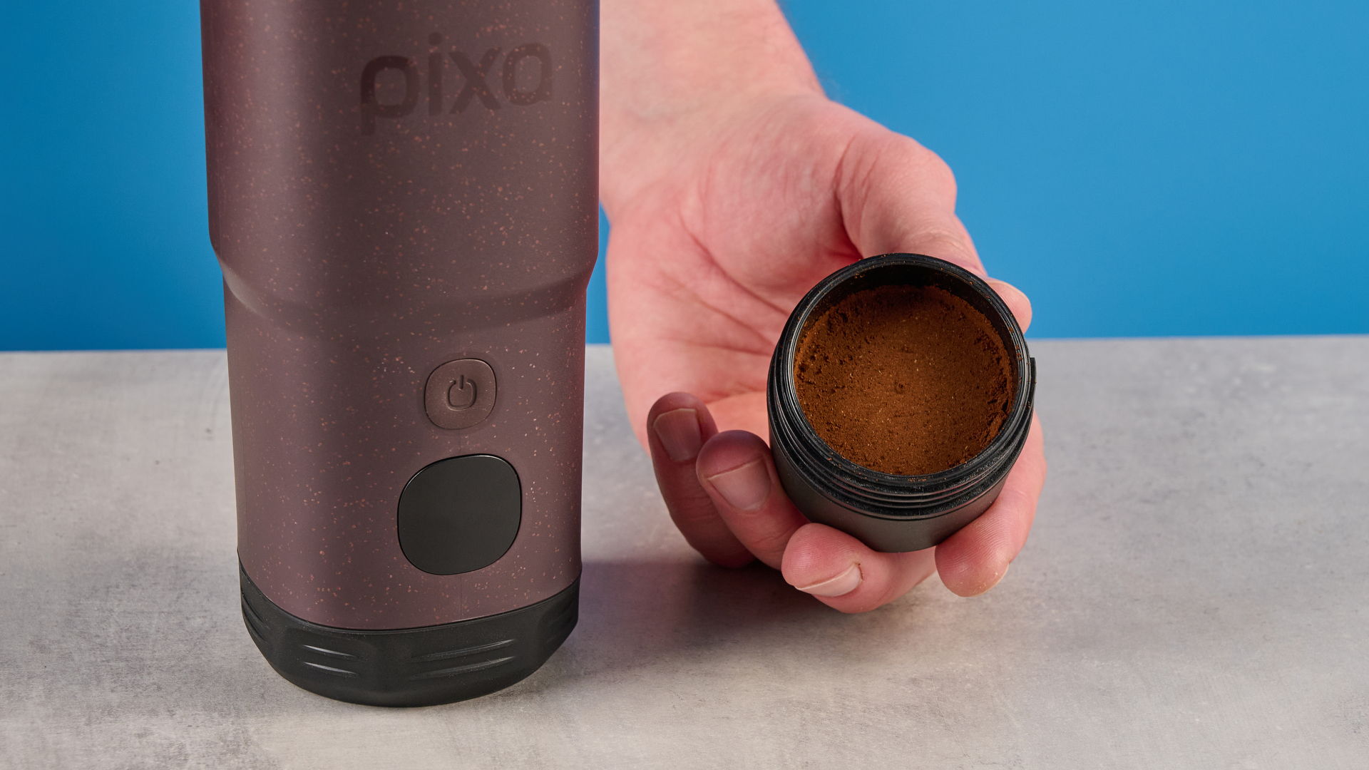 the wacaco pixapresso portable self-heating espresso maker in dark purple color showing usability with nespresso pods and ground coffee, ideal for vacations and camping