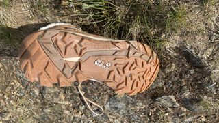 The sole of a hiking boot lying on the trail