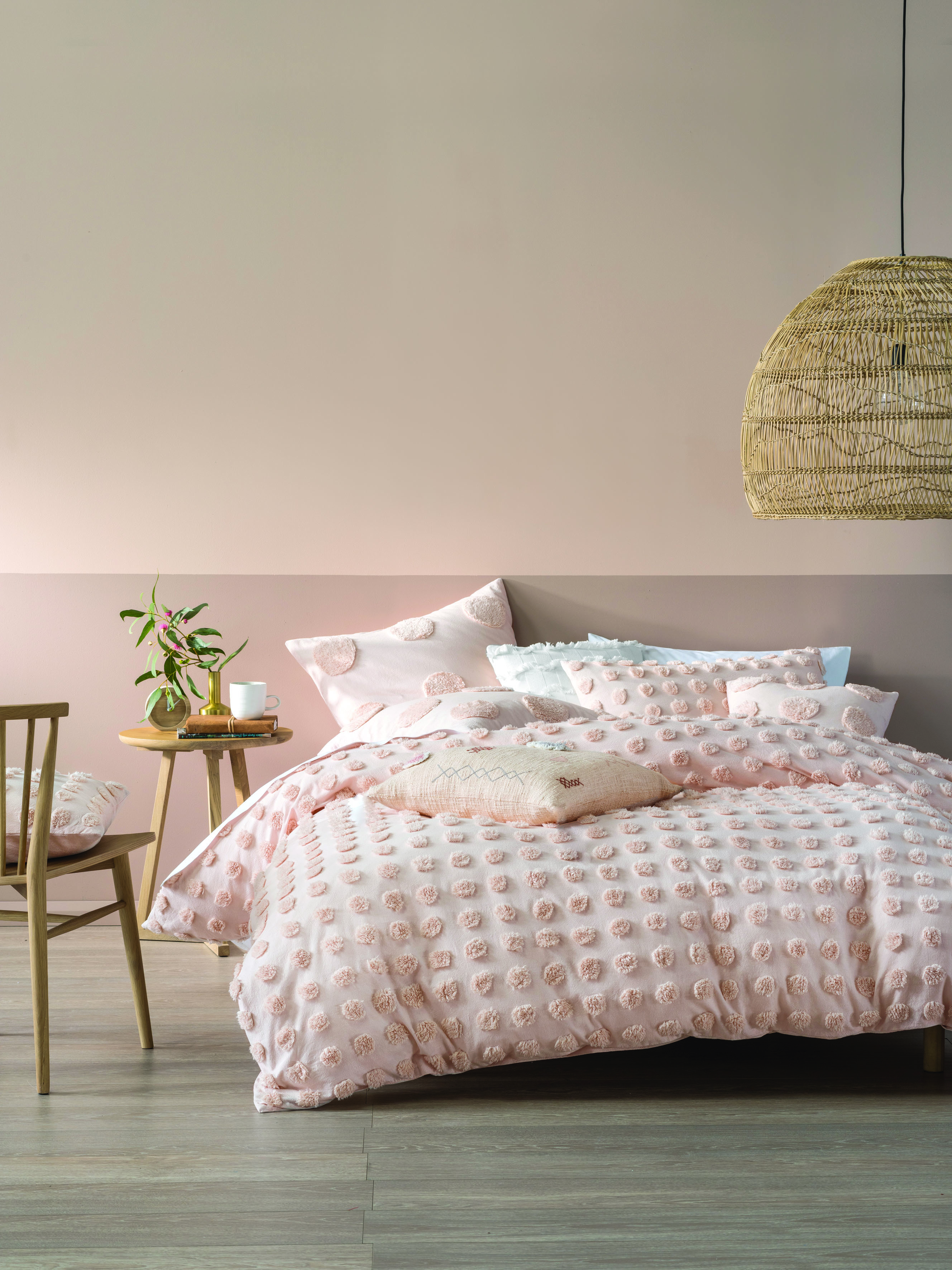 Pink bedroom with pom pom bedding and pink colour block walls