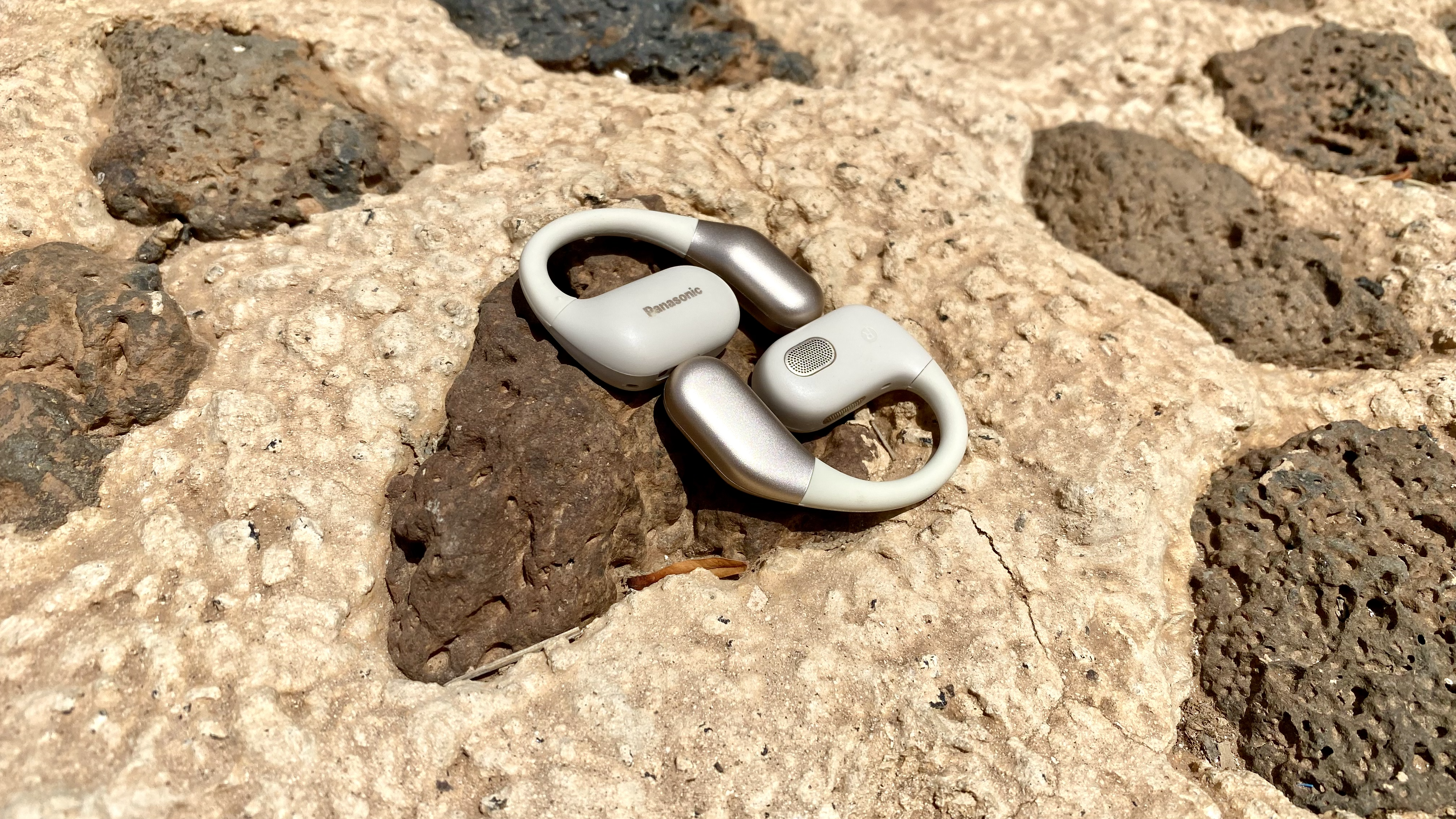Panasonic RB-F10 open earbuds on a rock