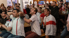 England football fans watch their team in a pub