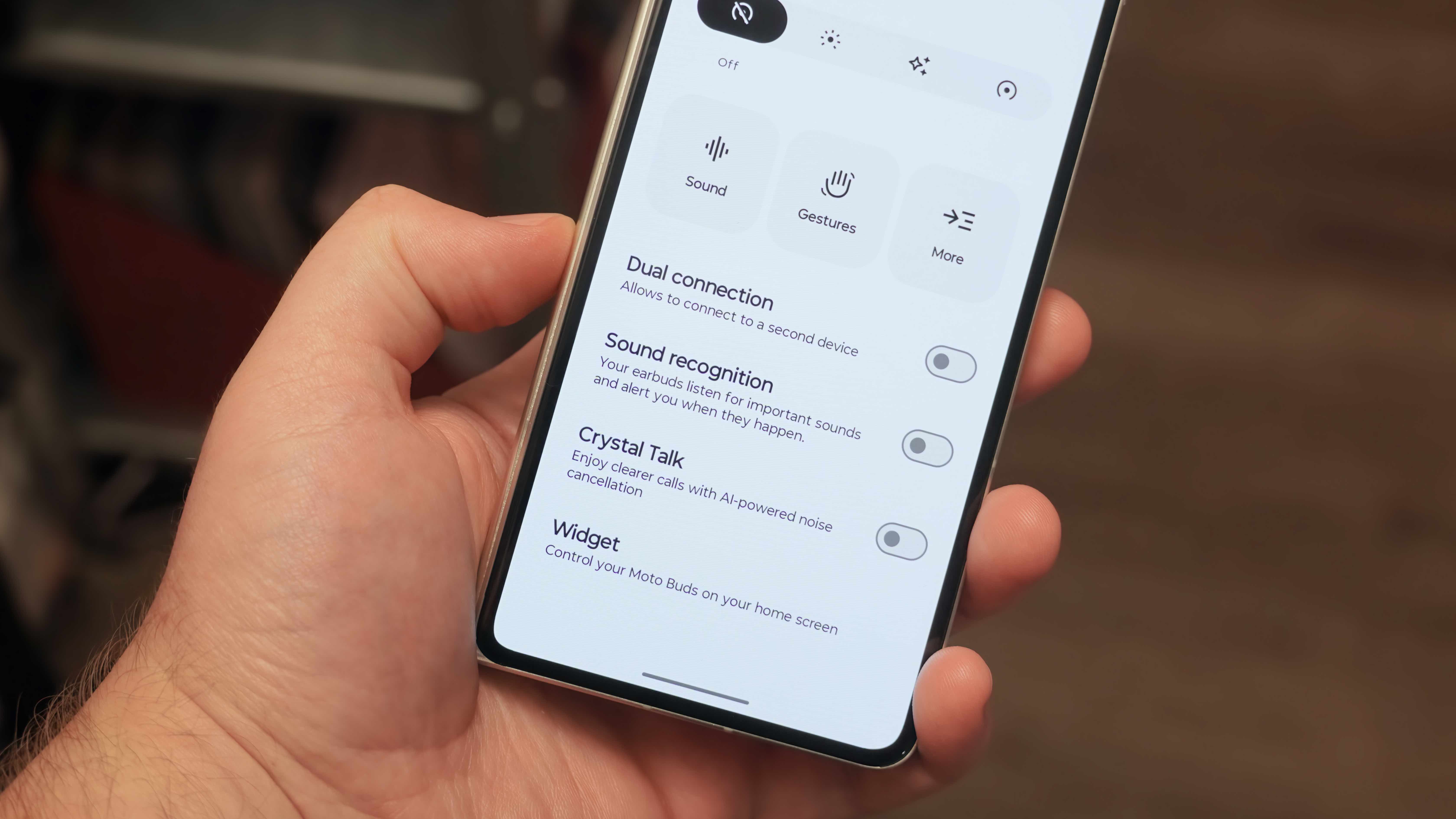 The Moto Buds 2 Plus alongside their companion app showing settings to change to improve audio quality.