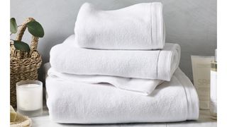 stack of white bathroom towels freshly laundered