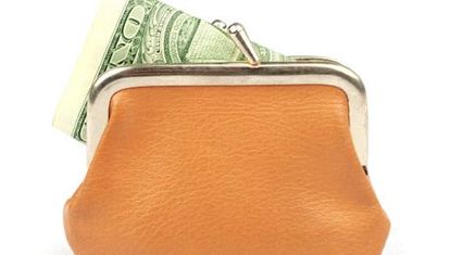 orange change purse with money sticking out of it