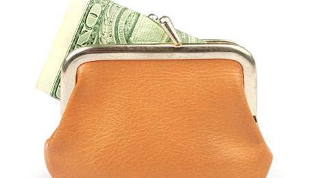 orange change purse with money sticking out of it