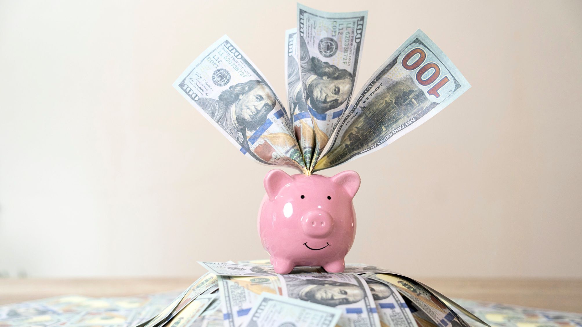 A piggy bank stuffed with $100 bills