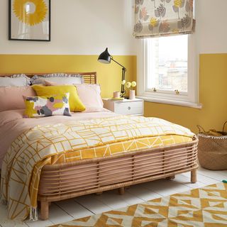 yellow coloured bedroom with bedside lamp and table