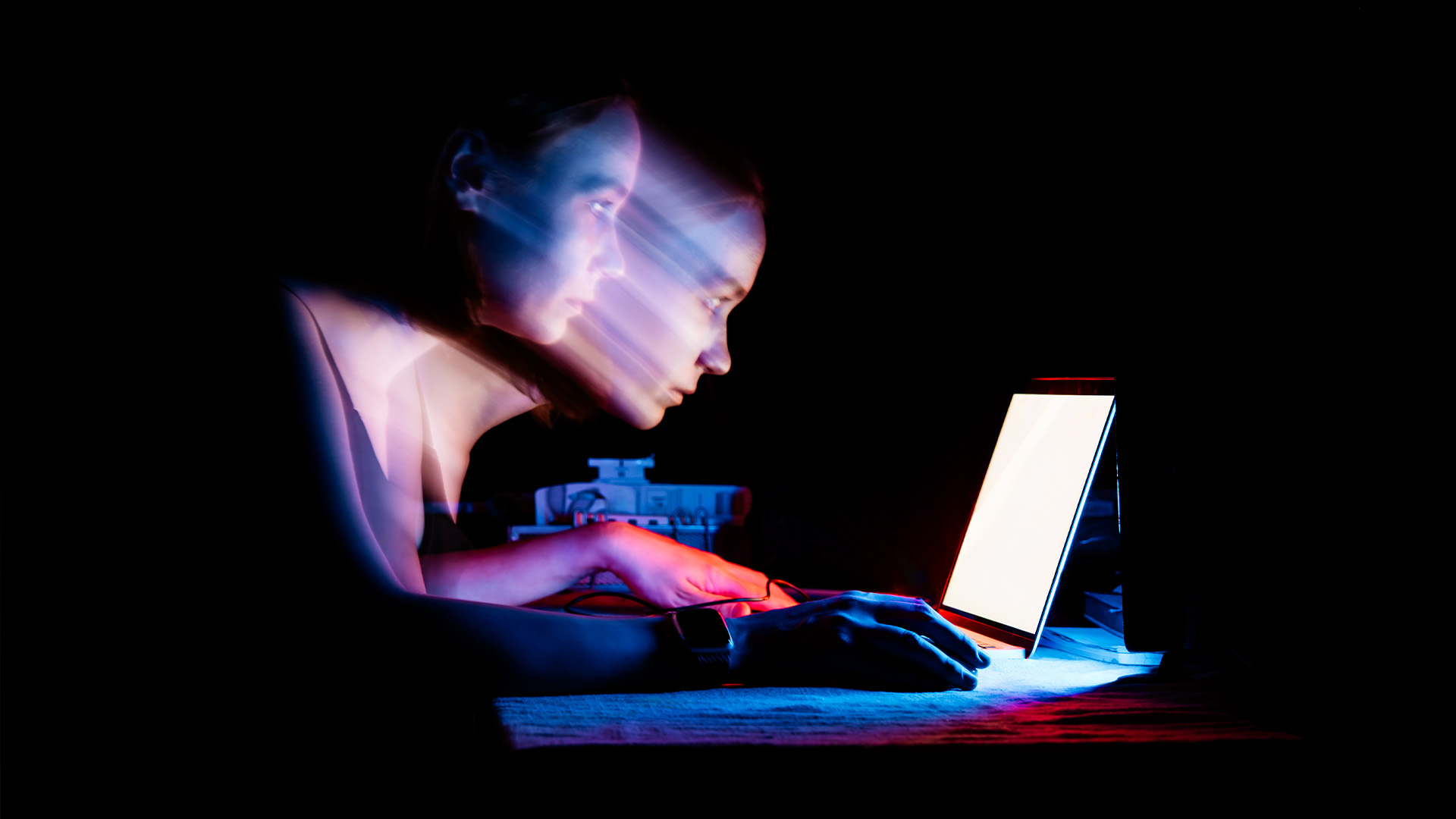 Woman looming over laptop
