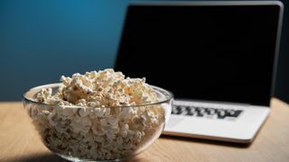 Popcorn in bowl and MacBook on table