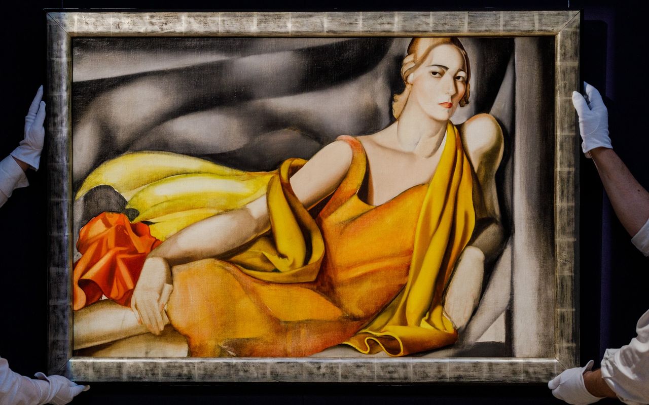 Sotheby&#039;s workers carry the Tamara de Lempicka 1929 painting &quot;Femme a la robe jaune&quot;