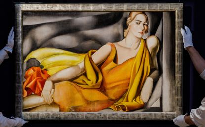 Sotheby&#039;s workers carry the Tamara de Lempicka 1929 painting &quot;Femme a la robe jaune&quot;